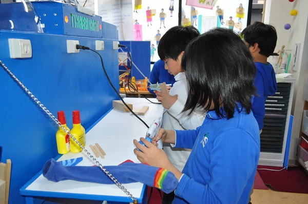 Small children doing some projects in their school workshop lab.Design thinking concept.