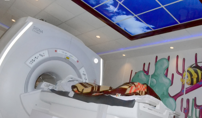 A patient being scanned through imaging machince
